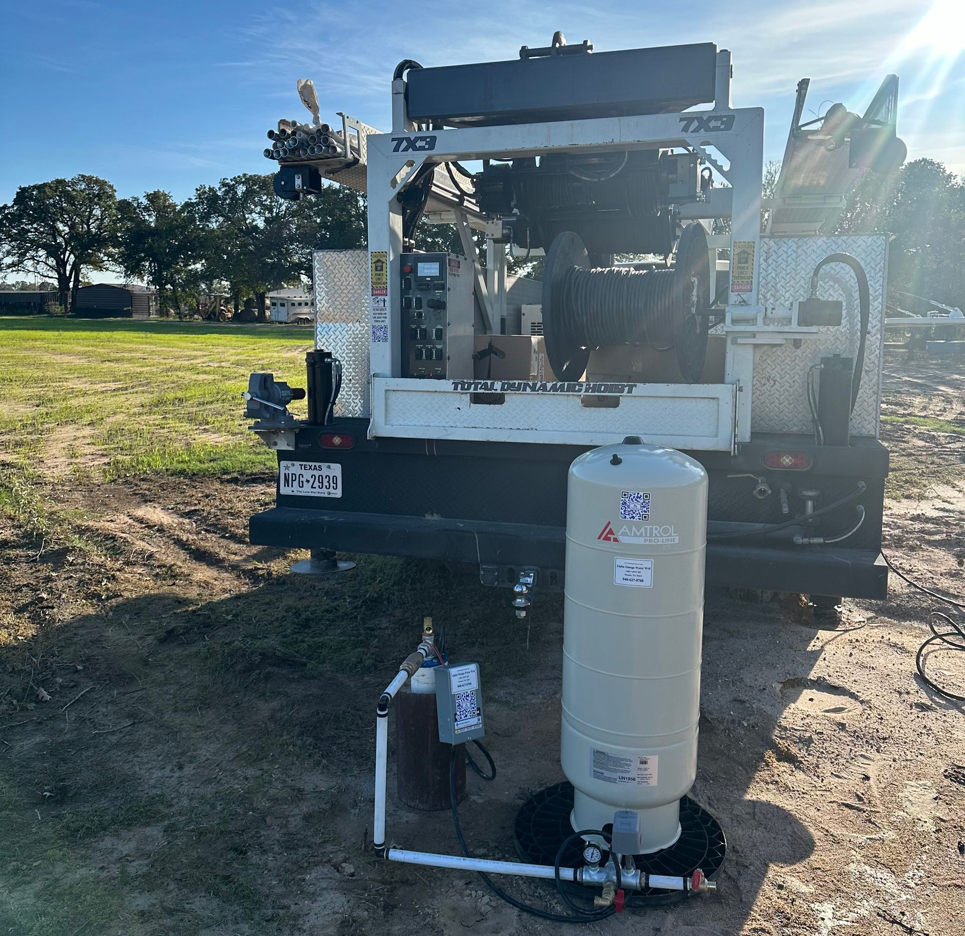 Utility truck with equipment in a field.