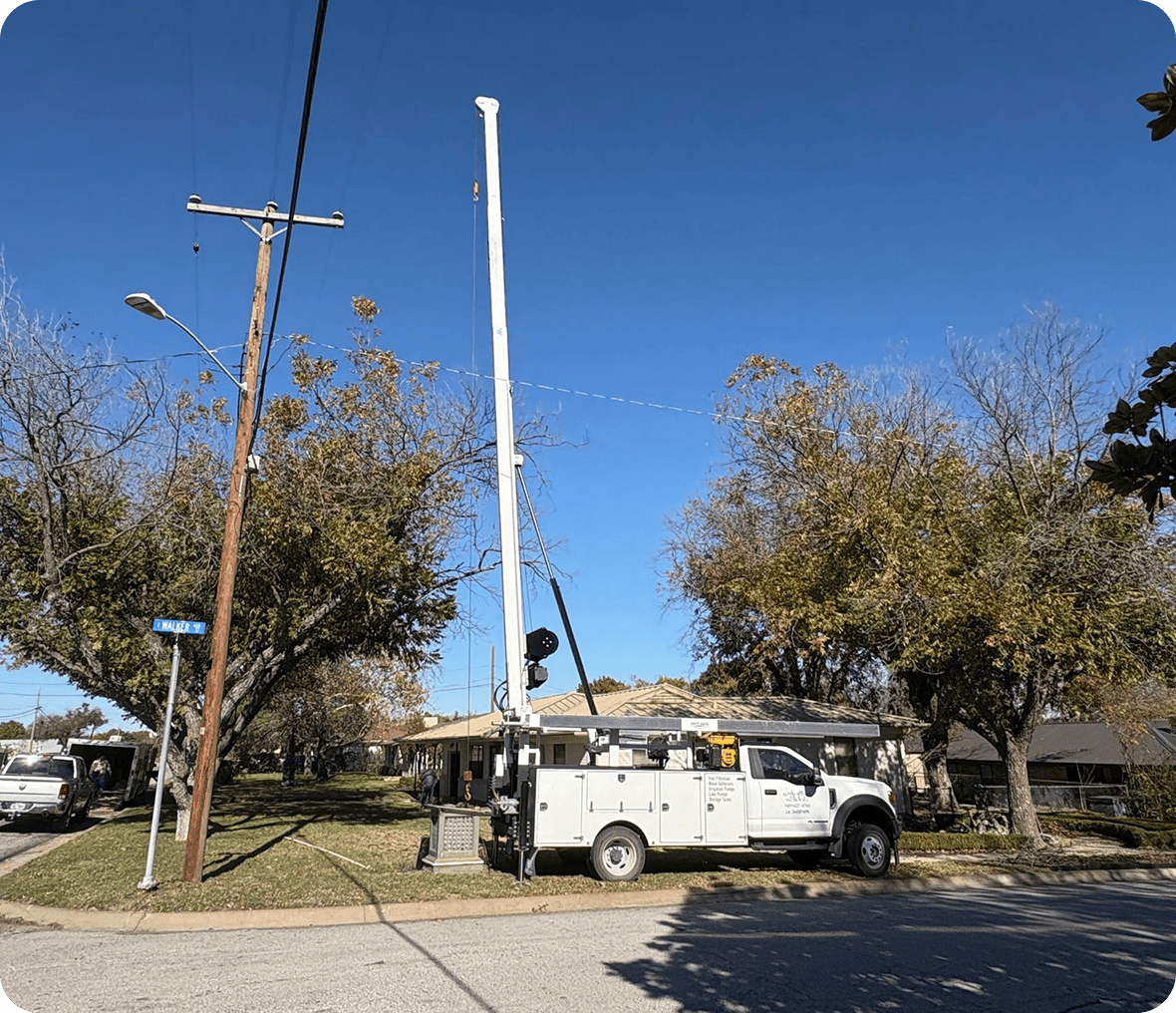 Utility truck near tall pole installation